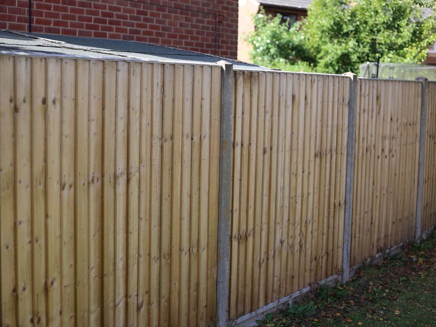 A closeboard fence on concrete posts and gravel boards, built to stay straight